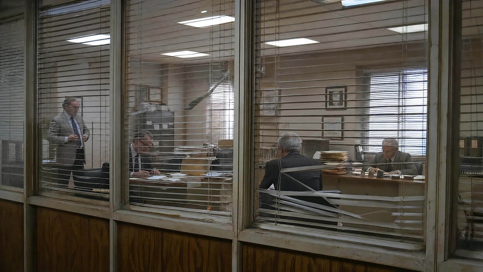 Outdated office glass privacy system with damaged traditional blinds and incomplete visual privacy