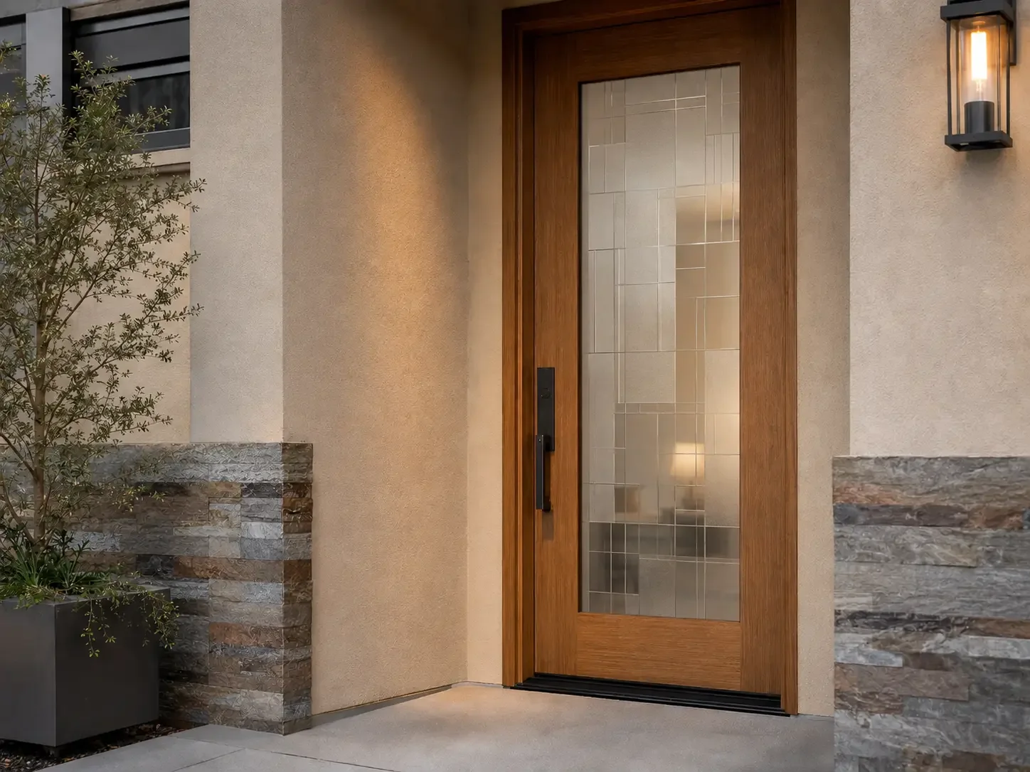Wood front door with geometric decorative privacy film applied across the full-height glass panel.