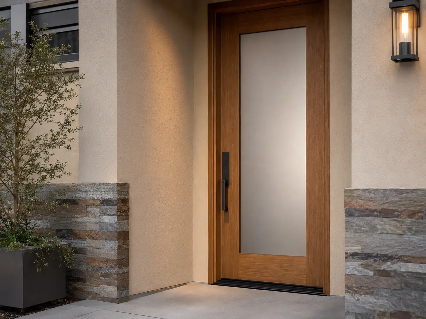Wood front door with permanently frosted glass providing privacy at a contemporary residential entrance.